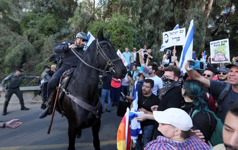 Mounted Israeli forces try to disperse protesters during a demonstration against the government's controversial judicial reform bill in Tel Aviv on March 9, 2023. (Photo by JACK GUEZ / AFP)
