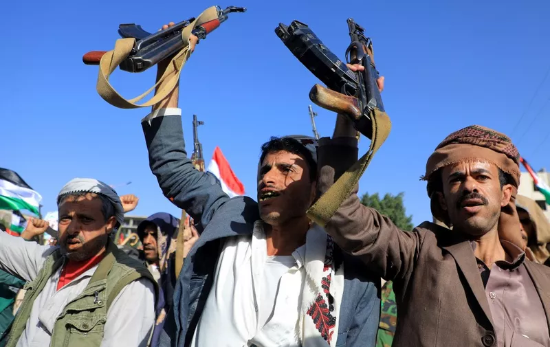 People brandish weapons during a march to show solidarity with the Palestinians of the West Bank and the Gaza Strip on October 13, 2023, in the Houthi-controlled Yemeni capital Sanaa. Thousands of protesters poured onto the streets of several Middle East capitals in support of Palestinians amid Israeli air strikes on Gaza in reprisal for a surprise Hamas attack. (Photo by MOHAMMED HUWAIS / AFP)