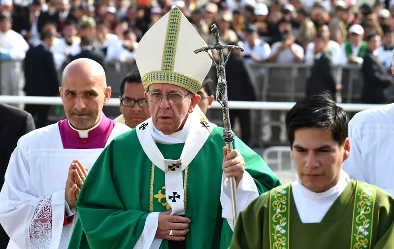 Pope Francis walks to the altar to celebrate mass at the Las Palmas air base in Lima on January 21, 2018. Pope Francis was preparing to wrap up his Latin American trip on Sunday with a mass at the air base where a million faithful were expected to hear him speak. On the last day of a week-long trip that has taken him to six cities in Chile and Peru, the 81-year-old pontiff began the day by delivering a homily to 500 nuns, as well as meeting the bishops of Peru. (Photo by Vincenzo PINTO / AFP)