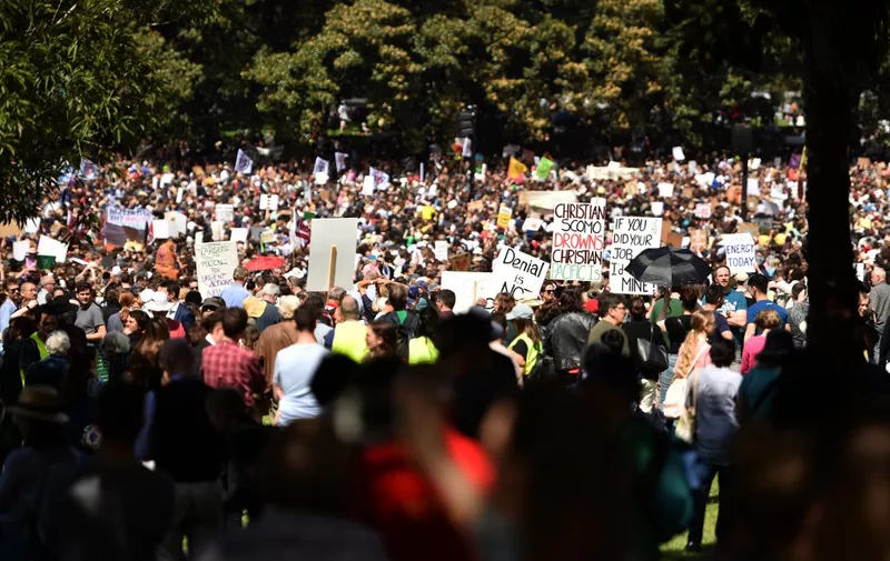 People attend a protest as part of the worlds largest climate strike in Sydney on September 20, 2019. - Children in Australia and the Pacific Islands kicked off a millions-strong global climate strike on September 20 -- heeding the rallying cry of teen activist Greta Thunberg and demanding adults take action to stave off environmental disaster. (Photo by PETER PARKS / AFP)
