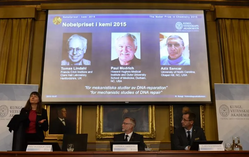 (L-R) Sara Snogerup Linse, Chairman of the Nobel Committee for Chemistry, Goran K Hansson, Secretary General of the Royal Swedish Academy of Sciences and Claes Gustafsson, member of the Nobel Committee for Chemistry, sit in front of a screen displaying the portraits of the winners of the Nobel Prize in Chemistry 2015 (L-R) Sweden's Tomas Lindahl, Paul Modrich of US and Turkish-American Aziz Sancar during a press conference on October 7, 2015 at the Royal Swedish Academy of Sciences in Stockholm. Sweden's Tomas Lindahl, Paul Modrich of the US and Turkish-American Aziz Sancar on Wednesday won the Nobel Chemistry Prize for work on how cells repair damaged DNA.     AFP PHOTO / JONATHAN NACKSTRAND