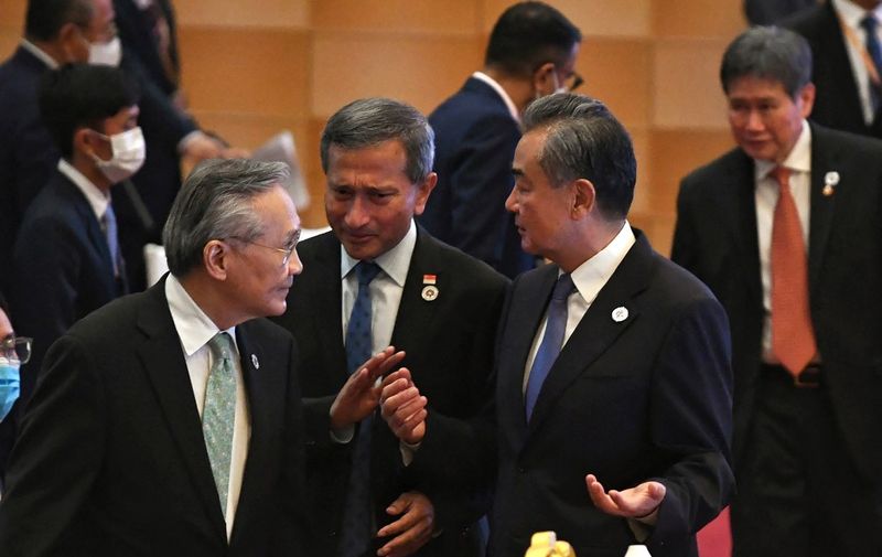 China's Foreign Minister Wang Yi (2nd R) talks to Singapore's Foreign Minister Vivian Balakrishnan (C) and Thailand's Foreign Minister Don Pramudwinai (L) at the ASEAN-China Ministerial Meeting during the 55th ASEAN Foreign Ministers' Meeting in Phnom Penh on August 4, 2022. (Photo by Tang Chhin Sothy / AFP)