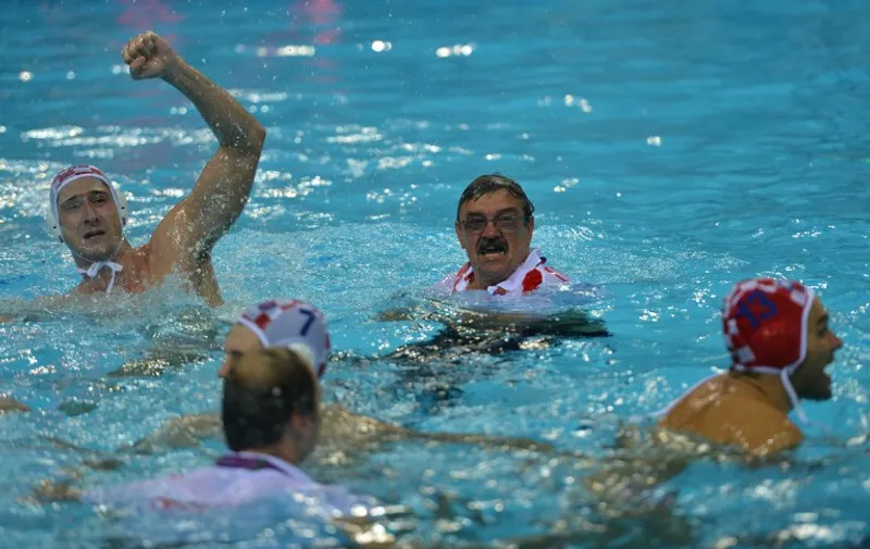 Croatia's coach Ratko Rudic (C) and players celebrate after the men's water polo gold medal match Croatia vs Italy at the London 2012 Olympic Games in London on August 12, 2012.         AFP PHOTO / KHALED DESOUKI