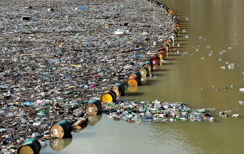 More than 5,000 cubic meters of waste and debris are seen at the dam of "Visegrad" water power plant, on river Drina, near Eastern-Bosnian town of Visegrad, on January 5, 2021. - Tons of waste that have been inappropriately disposed on unregulated dump sites, in communities along upper flow of river Drina and it's tributaries, have been flushed by the rivers, as water levels raised in previous days due to increased amount of rain. Build up of the waste and debris threatens normal operation of "Visegrad" dam and puts at risk normal operation on further two power plants in lower flow of the Drina river. (Photo by ELVIS BARUKCIC / AFP)