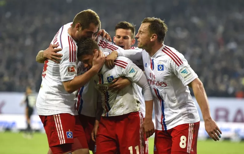 Hamburg's Croatian midfielder Ivo Ilicevic is congratulated by team members after scoring during the German first and second Bundesliga relegation football match Hamburger SV vs Karlsruher SC in Hamburg, northern Germany, on May 28, 2015. AFP PHOTO / TOBIAS SCHWARZ