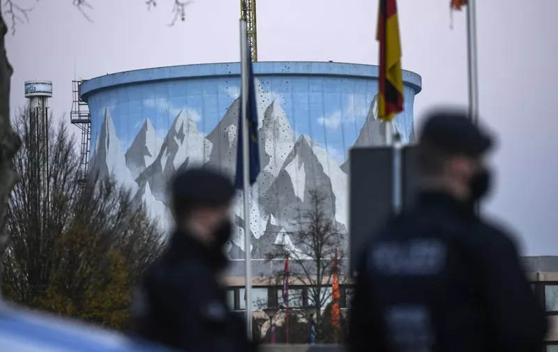 Police officers stand in front of the cooling reactor of the former nuclear power plant during a protest ahead of the party congress of far-right Alternative for Germany (AfD) party at the Wunderland in Kalkar, western Germany, on November 27, 2020. (Photo by Ina FASSBENDER / AFP)