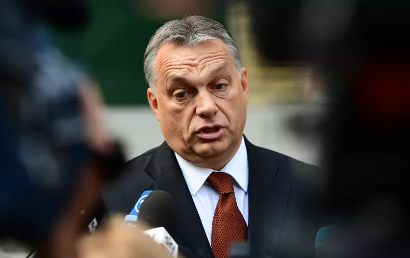 Hungarian Prime Minister Viktor Orban answers to the journalists in front of a polling station at a school in Budapest, on October 2, 2016. 
Hungarians vote in a referendum on taking migrants as part of an EU-wide mandatory quota scheme, a plan rejected by right-wing Prime Minister Viktor Orban. / AFP PHOTO / ATTILA KISBENEDEK