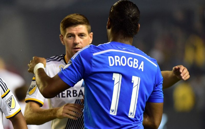Former English Premier League stars from Liverpool and Chelsea, Steven Gerrard and Didier Drogba, now of the LA Galaxy and Montreal Impact respectively, greet one another prior to kickoff in their MLS match on September 12, 2015 in Carson, California. AFP PHOTO /FREDERIC J.BROWN / AFP / FREDERIC J. BROWN