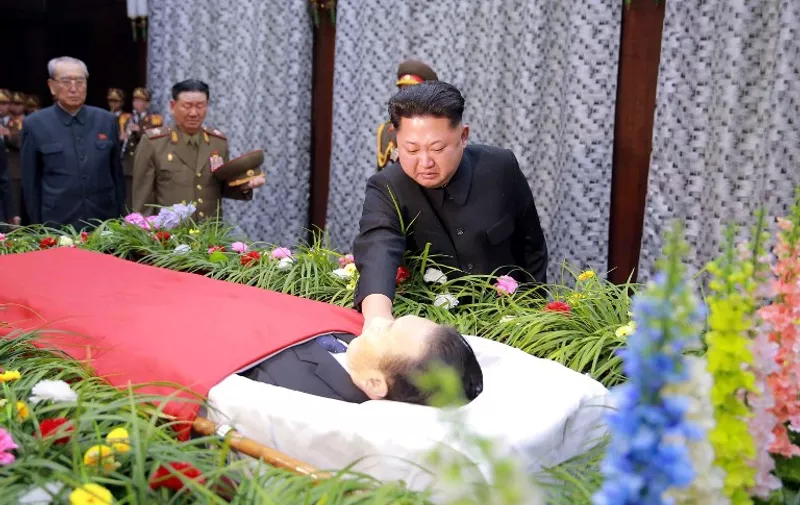 This picture taken by North Korea's official Korean Central News Agency (KCNA) on December 31, 2015 shows North Korean leader Kim Jong-Un looking at the body of Kim Yang-Gon, head of the North Korea's ruling Workers Party's unification front department, as he expressed condolences over his death in Pyongyang. Kim Yang-Gon, a top North Korean official in charge of ties with South Korea and reunification, was killed in a traffic accident, Pyongyang's state media said on December 30.  AFP PHOTO / KCNA via KNS    REPUBLIC OF KOREA OUT
THIS PICTURE WAS MADE AVAILABLE BY A THIRD PARTY. AFP CAN NOT INDEPENDENTLY VERIFY THE AUTHENTICITY, LOCATION, DATE AND CONTENT OF THIS IMAGE. THIS PHOTO IS DISTRIBUTED EXACTLY AS RECEIVED BY AFP.
---EDITORS NOTE--- RESTRICTED TO EDITORIAL USE - MANDATORY CREDIT "AFP PHOTO / KCNA VIA KNS" - NO MARKETING NO ADVERTISING CAMPAIGNS - DISTRIBUTED AS A SERVICE TO CLIENTS / AFP / KCNA / KNS