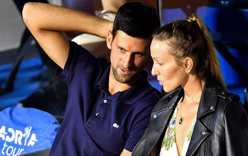 Serbian tennis player Novak Djokovic (L) talks to his wife Jelena during a match at the Adria Tour, Novak Djokovic's Balkans charity tennis tournament in Belgrade on June 14, 2020. - Novak Djokovic has also tested positive for coronavirus on June 23, 2020 along with Grigor Dimitrov, Borna Coric and Viktor Troicki, after taking part in an exhibition tennis tournament in the Balkans featuring world number one Novak Djokovic, raising questions over the sport's planned return in August. (Photo by Andrej ISAKOVIC / AFP)