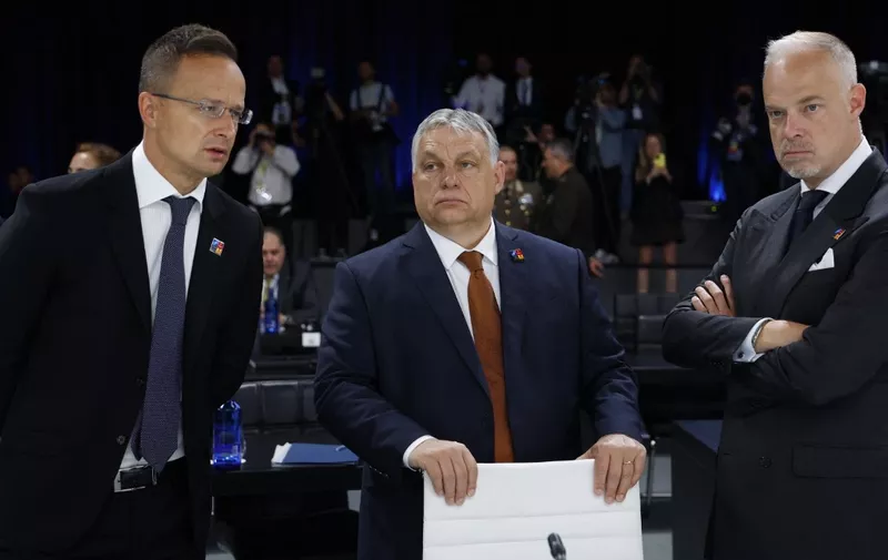 Hungary's President Viktor Orban (C), Hungary's Foreign Minister Peter Szijjarto (L) and Hungary's Defence Minister Kristof Szalay-Bobrovniczky (R) speak ahead of a meeting of The North Atlantic Council during the NATO summit at the Ifema congress centre in Madrid, on June 30, 2022. (Photo by JONATHAN ERNST / POOL / AFP)