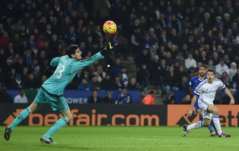 Leicester City's Algerian midfielder Riyad Mahrez (2R) shoots and scores past Chelsea's Spanish defender Cesar Azpilicueta (R) and Chelsea's Belgian goalkeeper Thibaut Courtois during the English Premier League football match between Leicester City and Chelsea at the King Power Stadium in Leicester, central England on December 14, 2015. 
AFP PHOTO / PAUL ELLIS
RESTRICTED TO EDITORIAL USE. No use with unauthorized audio, video, data, fixture lists, club/league logos or 'live' services. Online in-match use limited to 75 images, no video emulation. No use in betting, games or single club/league/player publications. / AFP / PAUL ELLIS