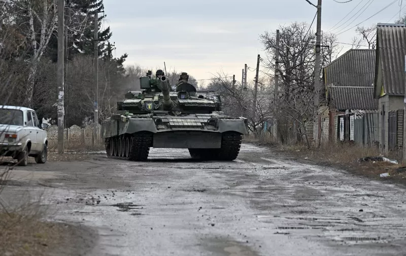 A Ukrainian tank drives through a village in Kharkiv region on March 3, 2023, amid the Russian invasion of Ukraine. (Photo by SERGEY BOBOK / AFP)