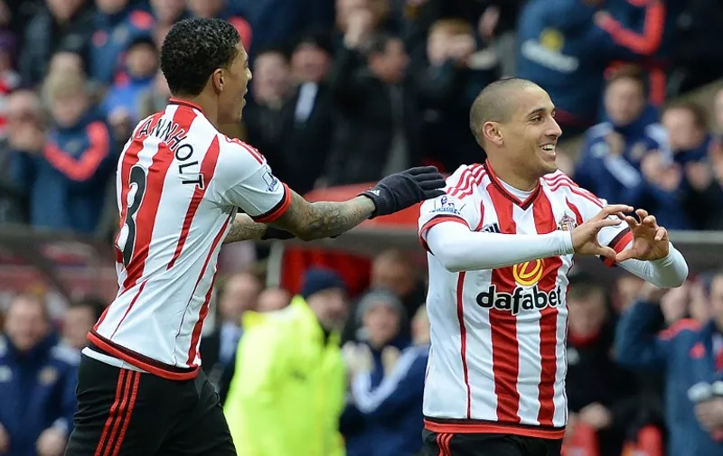 Sunderland's French-born Tunisian midfielder Wahbi Khazri (R) celebrates scoring his team's first goal with Sunderland's Dutch defender Patrick van Aanholt during the English Premier League football match between Sunderland and Manchester United at the Stadium of Light in Sunderland, northeast England on February 13, 2016. / AFP / OLI SCARFF / RESTRICTED TO EDITORIAL USE. No use with unauthorized audio, video, data, fixture lists, club/league logos or 'live' services. Online in-match use limited to 75 images, no video emulation. No use in betting, games or single club/league/player publications.  /