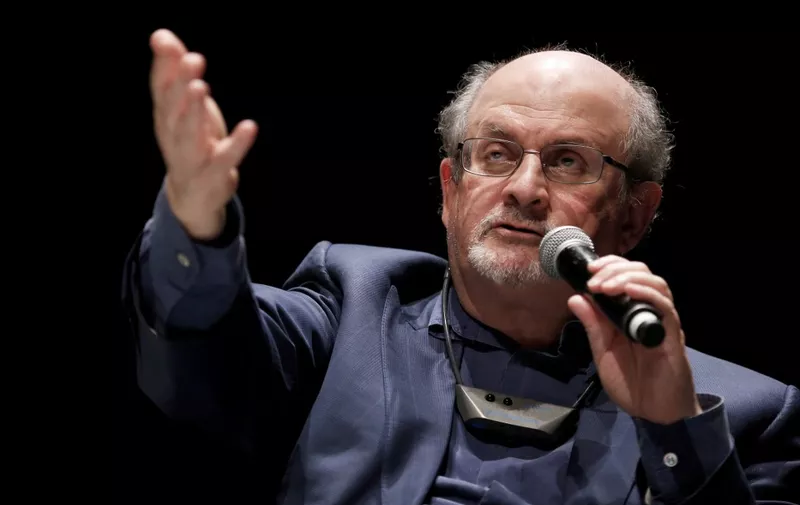 In this file photo taken on September 13, 2016, British writer Salman Rushdie speaks during the opening day of the Positive Economy Forum in Le Havre, northwestern France. - Rushdie, whose controversial writings made him the target of a fatwa that forced him into hiding, was stabbed in the neck by an attacker on stage Friday in western New York state, according to New York State Police. The attacked is in custody. (Photo by CHARLY TRIBALLEAU / AFP)
