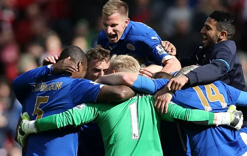 Leicester Citys players celebrate at full time in the English Premier League football match between Sunderland and Leicester City at the Stadium of Light in Sunderland, northeast England, on May 16, 2015. With the 0-0 draw at Sunderland, Leicester City are now safe from relegation and will play in the Premier League next season. AFP PHOTO / 

RESTRICTED TO EDITORIAL USE. No use with unauthorized audio, video, data, fixture lists, club/league logos or live services. Online in-match use limited to 45 images, no video emulation. No use in betting, games or single club/league/player publications. 