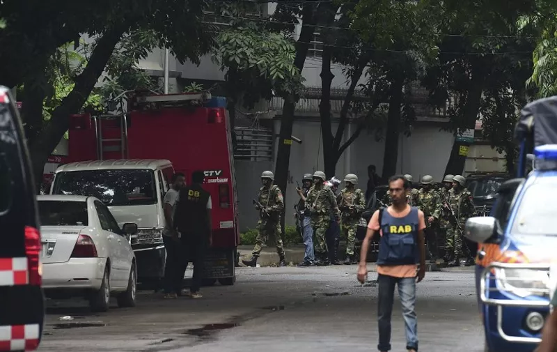 Bangladeshi army soldiers patrol a street during a rescue operation as gunmen take position in a restaurant in the Dhakas high-security diplomatic district on July 2, 2016 where several people including foreigners are believed to be trapped.
Thirteen hostages have been rescued after security forces ended a siege at a cafe in the Bangladeshi capital Dhaka, a top commander said. / AFP PHOTO / APF / STR