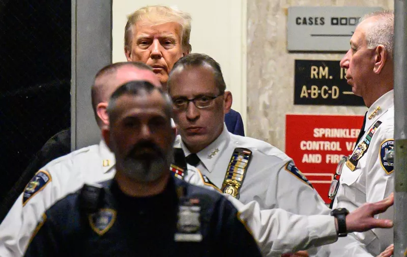 Former US president Donald Trump arrives at the courtroom at the Manhattan Criminal Court in New York on April 4, 2023 before his hearing. - Trump is charged with 34 felony counts of falsifying business records stemming from three pre-election hush-money cases, prosecutors said . (Photo by Ed JONES / AFP)