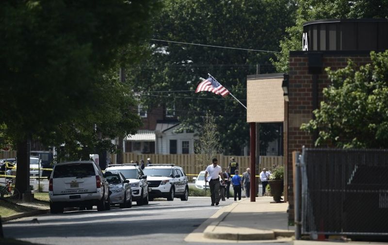 People walk near the crime scene of an early morning shooting in Alexandria, Virginia, June 14, 2017.
At least five people people including a top Republican congressman were wounded in a Washington suburb early Wednesday morning when a shooting erupted as they practiced for an annual baseball game between lawmakers. Senior congressman Steve Scalise was shot in the hip, according to fellow Republican lawmaker Mo Brooks who told CNN at least two law enforcement officers and one congressional staffer were also shot in the incident in Alexandria, Virginia.
 / AFP PHOTO / Brendan Smialowski