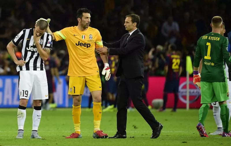 (L-R) Juventus' defender Leonardo Bonucci, Juventus' goalkeeper and captain Gianluigi Buffon and Juventus' coach Massimiliano Allegri react after the UEFA Champions League Final football match between Juventus and FC Barcelona at the Olympic Stadium in Berlin on June 6, 2015. FC Barcelona won the match 1-3.        AFP PHOTO / OLIVIER MORIN