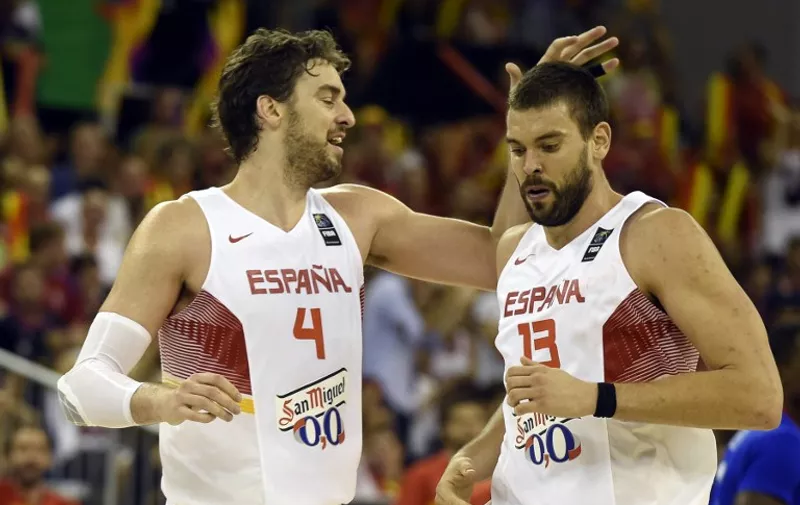 Spain's forward Pau Gasol (L) and Spain's centre Marc Gasol react during the 2014 FIBA World basketball championships group A match Spain vs France at the Palacio Municipal de Deportes in Granada on September 3, 2014.   AFP PHOTO/ JAVIER SORIANO