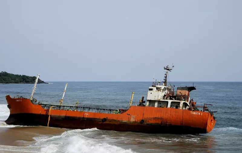 TO GO WITH AFP STORY BY ZOOM DOSSO
A picture taken on May 12, 2016, shows an empty oil tanker that drifted onto the beach in Robertsport, western Liberia. - Robertsport is known as a surfers' paradise, attracting beach bums from afar to its epic breaks and chilled nightlife, but when the ship disturbed its golden shores usually troubled only by baby crabs, it raised rumours of everything from an Islamist invasion to a ghost crew. Authorities in Liberia are investigating the Panama-flagged tanker, named Tamaya 1, which drifted onto the shore on May 3, but for now its backstory is unknown. (Photo by ZOOM DOSSO / AFP)