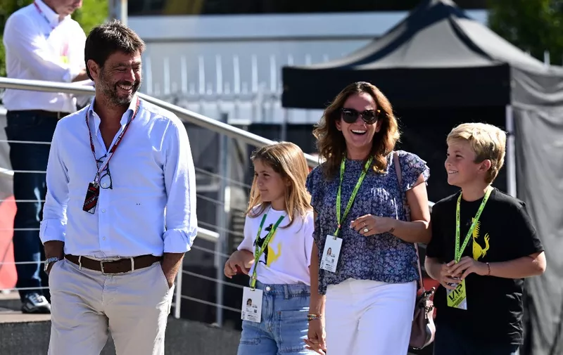 Italian businessman Andrea Agnelli (L) arrives with his family before the third practice session ahead of the Italian Formula One Grand Prix at the Autodromo Nazionale circuit in Monza on September 10, 2022. (Photo by Miguel MEDINA / AFP)