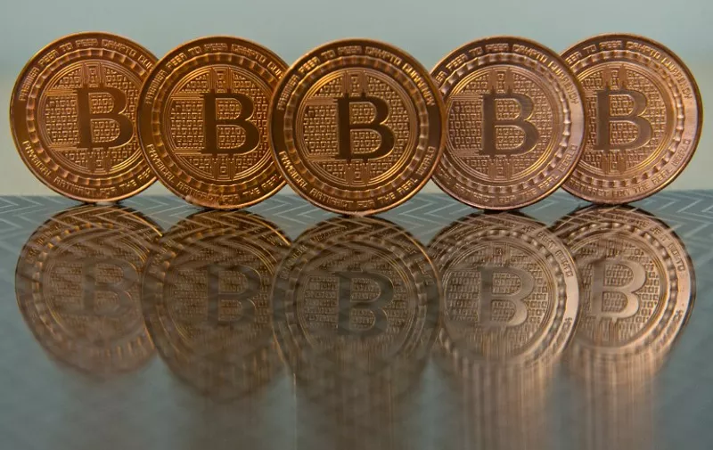 This June 17, 2014 photo taken in Washington, DC shows bitcoin medals. Bitcoin uses peer-to-peer technology to operate with no central authority or banks; managing transactions and the issuing of bitcoins is carried out collectively by the network. AFP PHOTO / Karen BLEIER / AFP / KAREN BLEIER