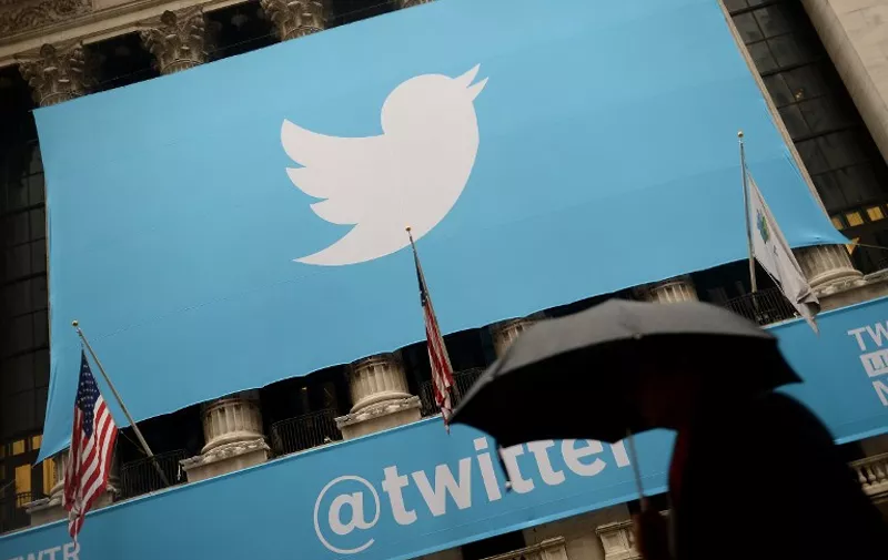 (FILES) This November 7, 2013 file photo shows the logo of Twitter  on the front of the New York Stock Exchange (NYSE) in New York. Twitter has become the latest online platform to ban "revenge porn," or the posting of sexually explicit images of a person without consent. In updated terms of service released March 11, 2015, Twitter explicitly banned "intimate photos or videos that were taken or distributed without the subject's consent." The update comes following Reddit's announcement last month of a similar ban, which came after the online bulletin board was criticized for allowing the distribution of hacked nude pictures of Hollywood stars. AFP PHOTO/EMMANUEL DUNAND