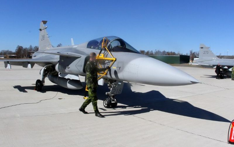 A Swedish Air Force JAS-39 Gripen fighter prepares for take off during the Lithuanian - NATO air force exercise at the air force base near Siauliai Zuokniai, Lithunaia on April 1, 2014. The air training event will involve F-15C Eagle of the US Air Force currently deployed on NATOs Baltic Air Policing mission, JAS-39 Gripen aircraft of the Swedish Air Force, C-27J Spartan transport aircraft and Mi-8 helicopter of the Lithuanian Air Force. Furthermore, NATO Airborne Warning and Control System (AWACS) aircraft based in Germany and US KC-135R air refuelling aircraft are expected to join the exercise.   AFP PHOTO / PETRAS MALUKAS / AFP / PETRAS MALUKAS