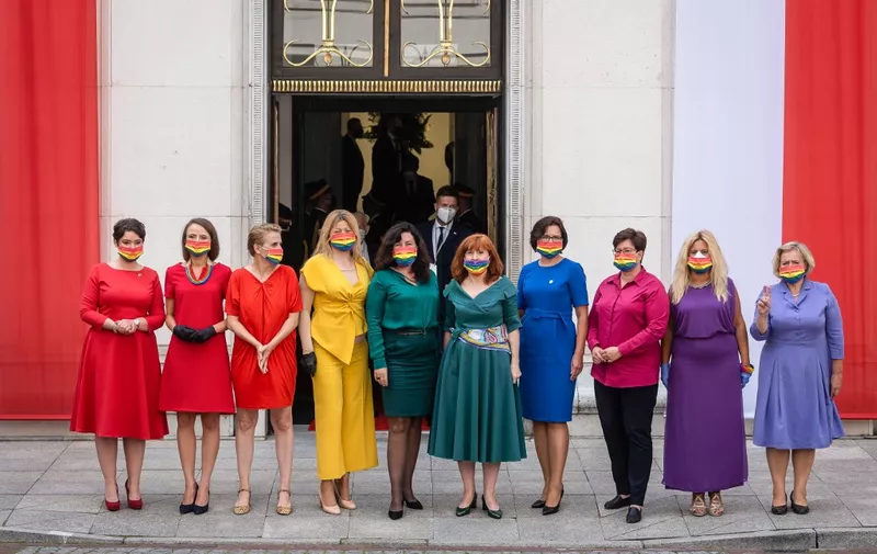 Left wing parliamentarians dressed in the colors of the rainbow pose in front of the Polish Parliament (Sejm) building after Polish President Andrzej Duda (not in picture) was sworn in for his second term on August 6, 2020 in Warsaw. (Photo by Wojtek RADWANSKI / AFP)