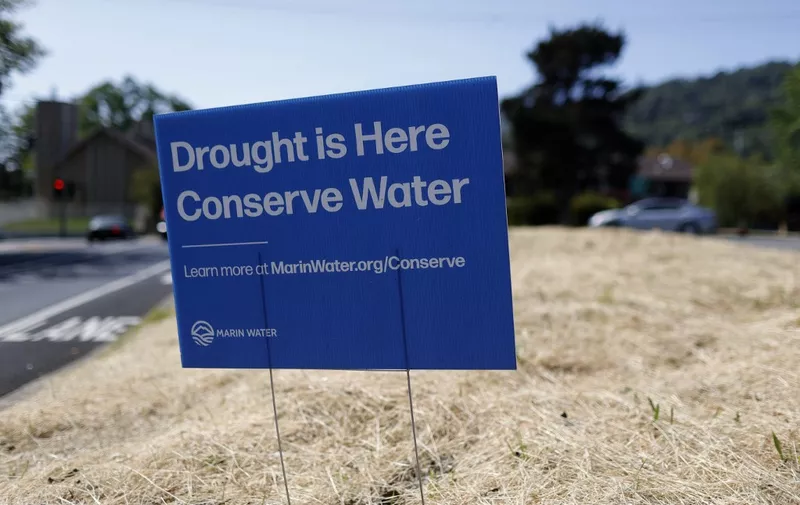 SAN ANSELMO, CALIFORNIA - APRIL 23: A sign advocating water conservation is posted in a field of dry grass on April 23, 2021 in San Anselmo, California. As the worsening drought takes hold in the state of California, Marin County became the first county in the state to impose mandatory water-use restrictions that are set to take effect May 1. Residents will be ordered to refrain from washing cars at home, refilling pools and watering lawns will only be allowed once a week. Earlier this week, California Gov. Gavin Newsom declared a drought emergency in Sonoma and Mendocino counties.   Justin Sullivan/Getty Images/AFP (Photo by JUSTIN SULLIVAN / GETTY IMAGES NORTH AMERICA / Getty Images via AFP)