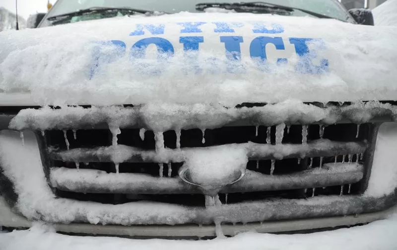 A police car is frozen after winter storm Nemo covered New York City with 4 to 8 inches (10-20cms) of snow on February 9, 2013. The storm was forecast to bring the heaviest snow to the densely-populated northeast corridor so far this winter, threatening power and transport links for tens of millions of people and the major cities of Boston and New York. New York and other regional airports saw more than 4,500 cancellations ahead of what the National Weather Service called "a major winter storm with blizzard conditions" along most of the region's coastline. AFP PHOTO / MEHDI TAAMALLAH / AFP / MEHDI TAAMALLAH