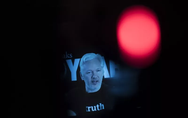 Julian Assange, founder of the online leaking platform WikiLeaks, is seen on a screen as he addresses journalists via a live video connection during a press conference on the platform's 10th anniversary on October 4, 2016 in Berlin.
WikiLeaks celebrates its 10th birthday defiantly proud as the pioneer of online leaking platforms, while its controversial founder vows to pursue its work despite widespread criticsm. / AFP PHOTO / STEFFI LOOS