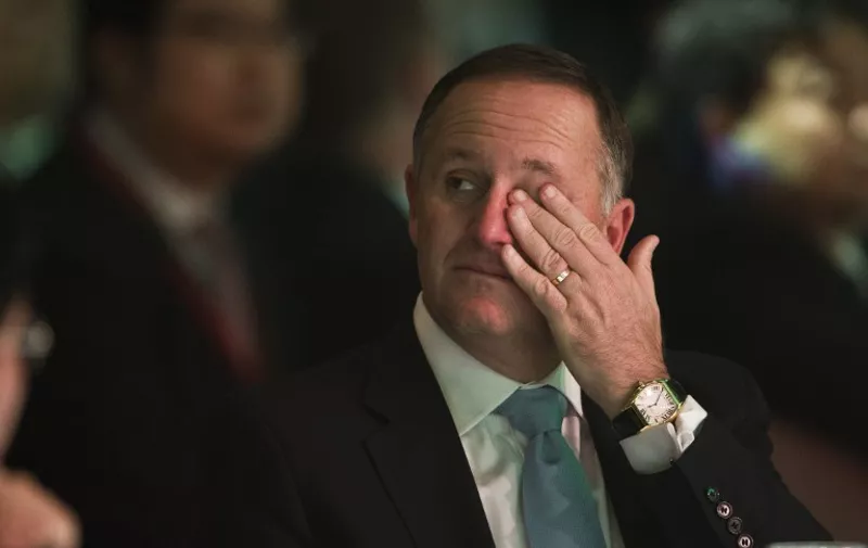 New Zealand Prime Minister John Key listens to Chinese President Xi Jinping's address in Auckland on November 21, 2014.  Xi is on a two day trip to New Zealand before heading to Fiji to meet leaders from Pacific island nations, where China has become a major aid donor in recent years.    AFP PHOTO / POOL