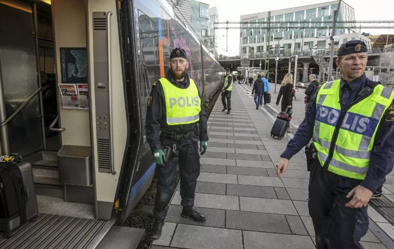 Swedish police prepare to check an incoming train at the Swedish end of the bridge between Sweden and Denmark in Malmo, Sweden, on November 12, 2015. The Swedish government on November 11, 2015 said it would temporarily reinstate border checks to deal with an unprecedented influx of migrants, making it the latest country in Europe's passport-free Schengen zone to tighten its borders over the crisis. AFP PHOTO / TT NEWS AGENCY / STIG-AKE JONSSON +++ SWEDEN OUT +++