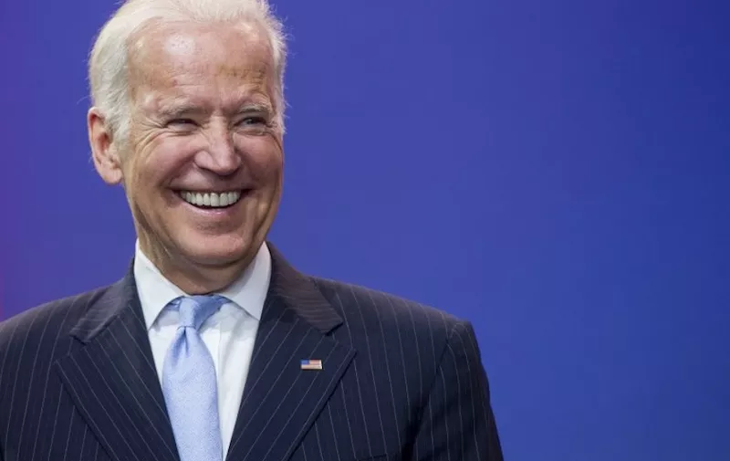 US Vice President Joe Biden laughs during a celebration of the 5th anniversary of Joining Forces and the 75th anniversary of the USO at Andrews Air Force Base in Maryland, May 5, 2016. (Photo by SAUL LOEB / AFP)