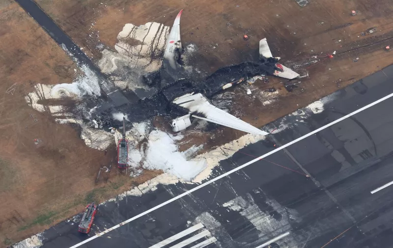 An aerial photo shows Japan Airlines flight 516  burnt on the runway at Haneda Airport in Ota Ward, Tokyo on Jan.3rd, 2024.  According to the Transport Ministry, the plane caught fire from the rear of the fuselage the moment after the plane collided with a Japan Coast Guard (JCG) aircraft. all 379 passengers and crew members of the JAL flight 516 managed to escape from the fire after a collision with a JCG aircraft, while five of the JCG plane crew had died. ( The Yomiuri Shimbun via AP Images ) (Photo by Ryoichiro Kida / Yomiuri / The Yomiuri Shimbun via AFP)