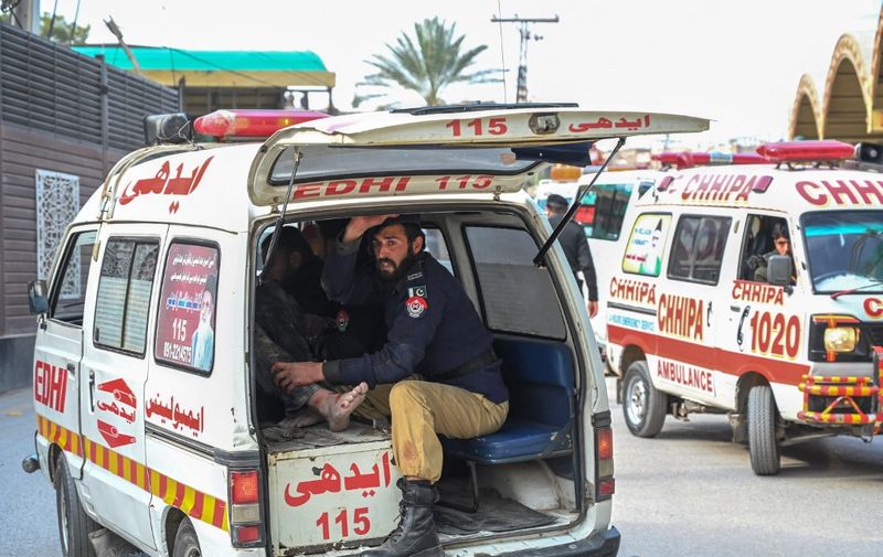 An ambulance transports injured blast victims outside the police headquarters in Peshawar on January 30, 2023. - A blast at a mosque inside a police headquarters in Pakistan on January 30 killed and wounded worshippers, hospital officials said. (Photo by Abdul MAJEED / AFP)