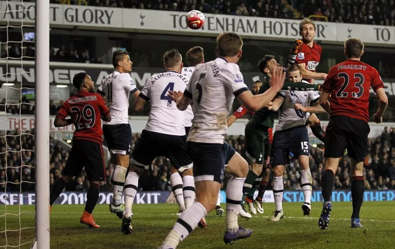 West Bromwich Albion's English defender Craig Dawson (Top R) scores his team's first goal
during the English Premier League football match between Tottenham Hotspur and West Bromwich Albion at White Hart Lane in London, on April 25, 2016. / AFP PHOTO / IKIMAGES / IKimages / RESTRICTED TO EDITORIAL USE. No use with unauthorized audio, video, data, fixture lists, club/league logos or 'live' services. Online in-match use limited to 45 images, no video emulation. No use in betting, games or single club/league/player publications.