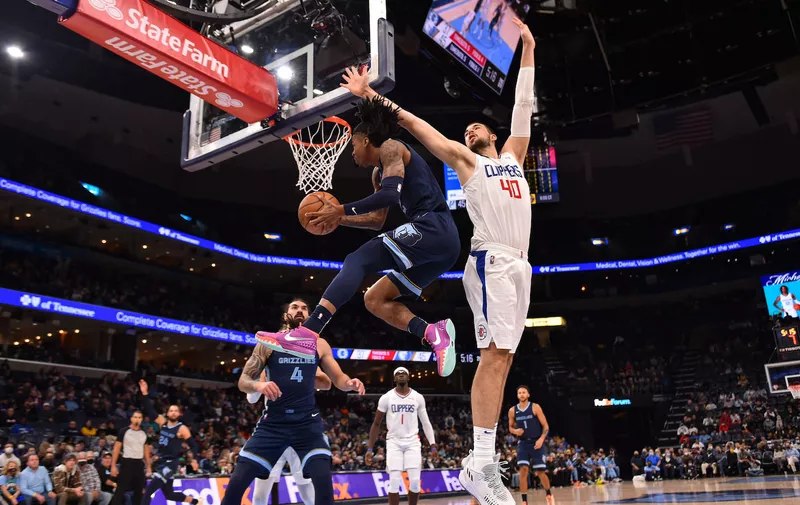 Nov 18, 2021; Memphis, Tennessee, USA; Memphis Grizzlies guard Ja Morant (12) goes to the basket against LA Clippers center Ivica Zubac (40) during the first half at FedExForum. Mandatory Credit: Justin Ford-USA TODAY Sports