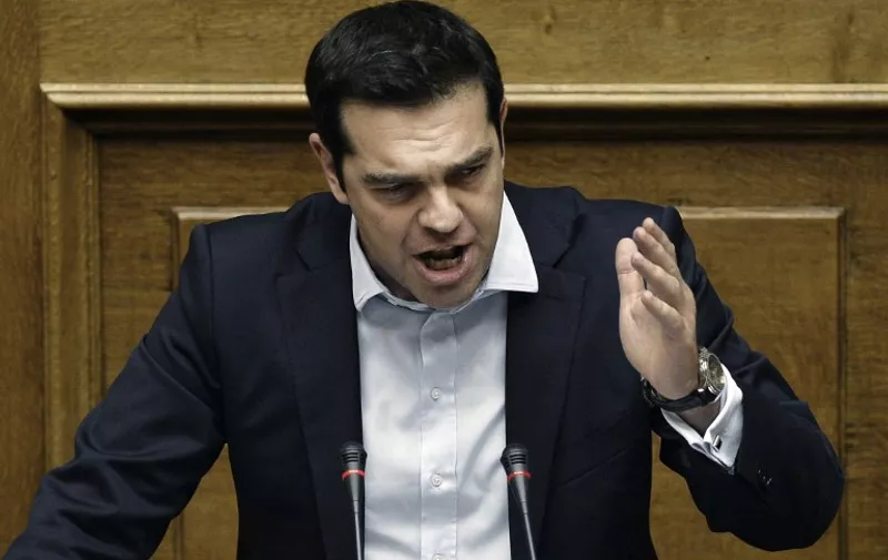 Greek Prime Minister Alexis Tsipras delivers a speech during a parliamentary session in Athens on June 28, 2015. Greece will hold a referendum on July 5 on the outcome of negotiations with its international creditors taking place in Brussels today. AFP PHOTO / ANGELOS TZORTZINIS