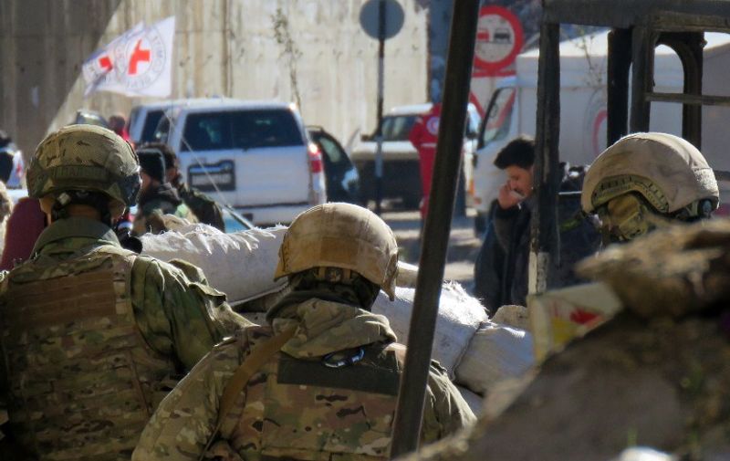 Russian soldiers gather in the government held side of the embattled city of Aleppo before the start on an evacuation operation of rebel fighters and their families from rebel-held areas on December 15, 2016. 
Russia, Syrian military sources and rebel officials confirmed that a new agreement had been reached after a first evacuation plan collapsed the day before amid fresh fighting. Syrian state television reported that some 4,000 rebels and their families were to be evacuated.


 / AFP PHOTO / STRINGER