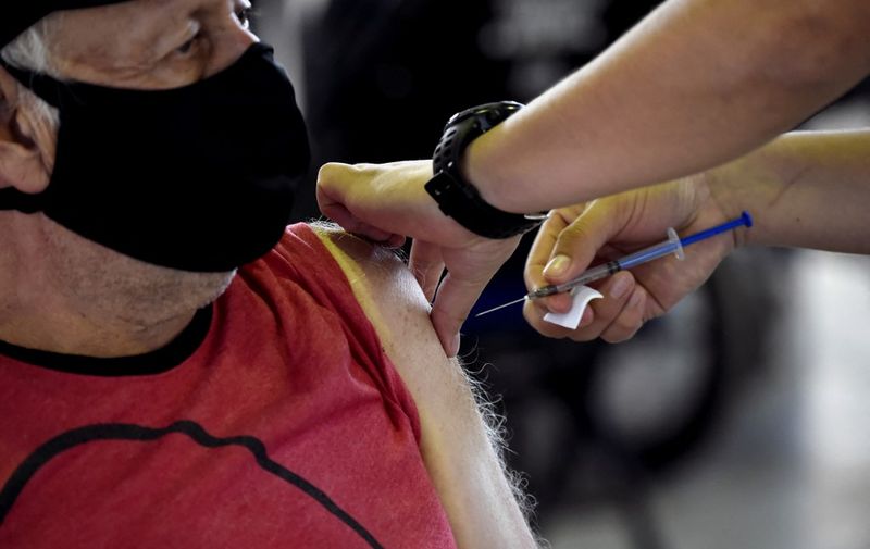 A nurse gives a shot of the Russian Sputnik V vaccine against COVID-19 at Sports Palace in Mexico City, on February 28, 2021. (Photo by ALFREDO ESTRELLA / AFP)