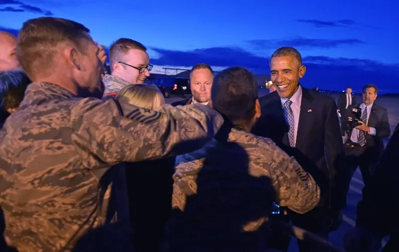 US President Barack Obama greets base personnel and well-wishers upon arrival at Hill Air Force Base on April 2, 2015 in Utah. AFP PHOTO/MANDEL NGAN