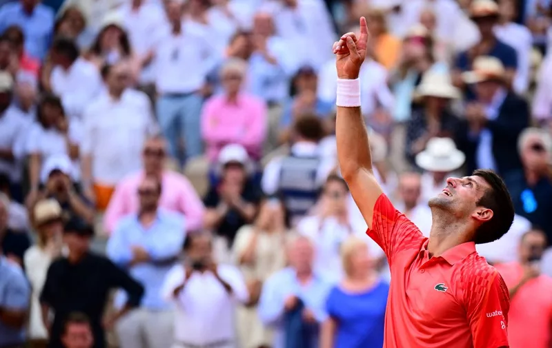 Serbia's Novak Djokovic gestures as he celebrates his victory over Norway's Casper Ruud during their men's singles final match on day fifteen of the Roland-Garros Open tennis tournament at the Court Philippe-Chatrier in Paris on June 11, 2023. (Photo by Emmanuel DUNAND / AFP)
