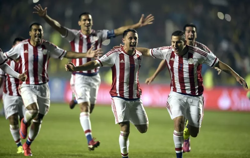 Paraguay's players celebrate after defeating Brazil in the penalty shoot-out of their 2015 Copa America football championship quarter-final match, in Concepcion, Chile, on June 27, 2015.   AFP PHOTO / JUAN MABROMATA