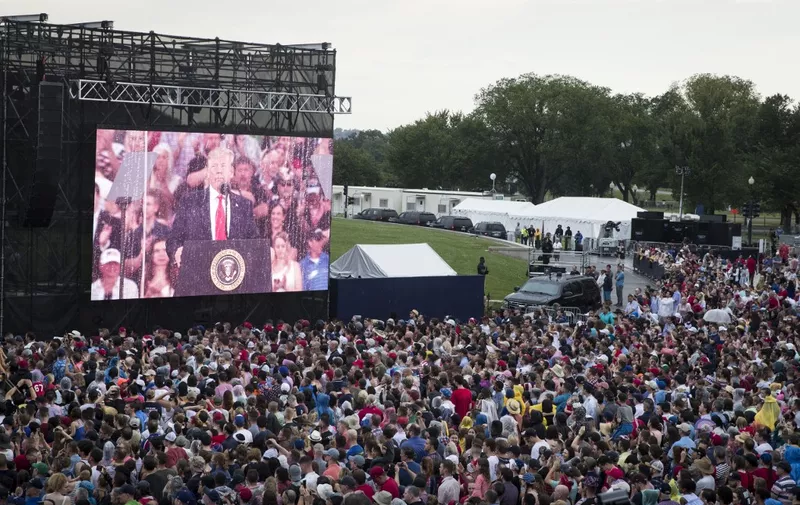 WASHINGTON, DC - JULY 04: A screen projects a video feed of President Donald Trump as he delivers remarks during the "Salute to America" ceremony in front of the Lincoln Memorial, on July 4, 2019 in Washington, DC. The presentation featured armored vehicles on display, a flyover by Air Force One, and several flyovers by other military aircraft.   Sarah Silbiger/Getty Images/AFP