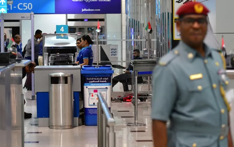 A police officer stands at a security gate of Dubai Airport's terminal 3 on October 10, 2018. -  (Photo by GIUSEPPE CACACE / AFP)