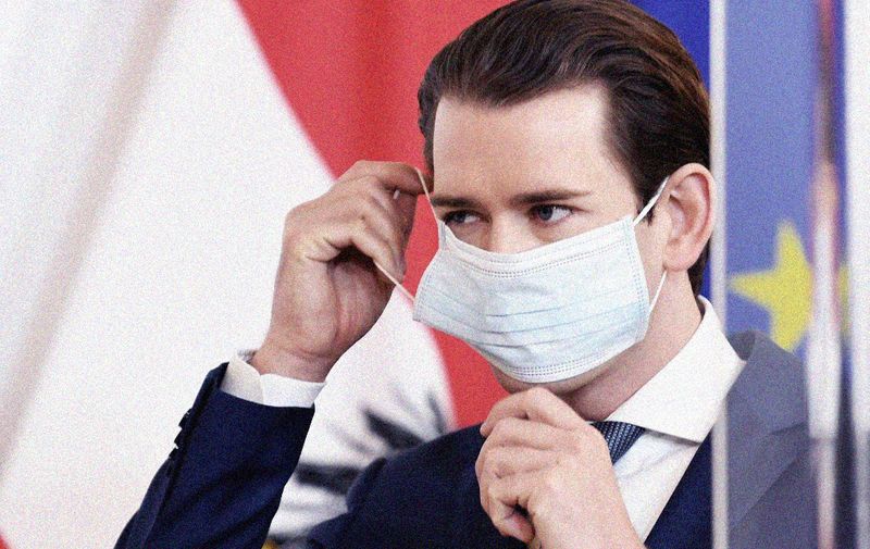 Austrian Chancellor Sebastian Kurz puts a face mask on during a press conference on the situation amid the novel coronavirus Covid-19 pandemic on April 14, 2020 in Vienna. (Photo by ROLAND SCHLAGER / APA / AFP) / Austria OUT